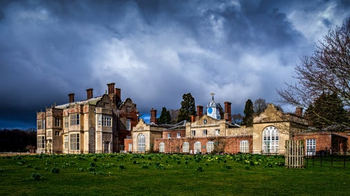 View of the house against dramatic clouds at Felbrigg Hall, Norfolk